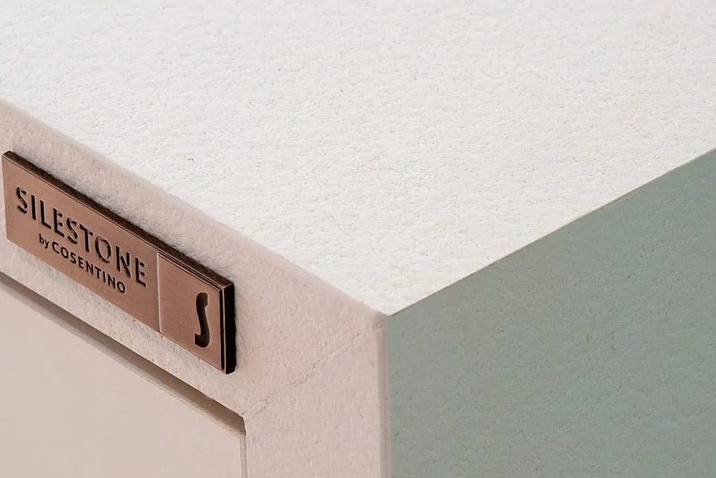 corner of a table with a Silestone name plate