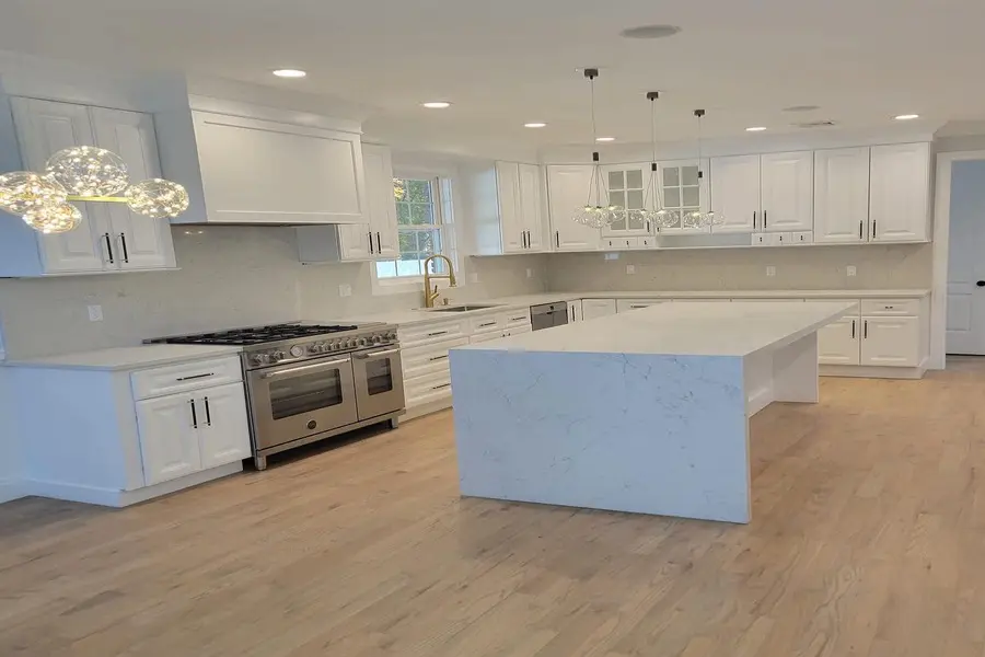 a huge kitchen area with a white island