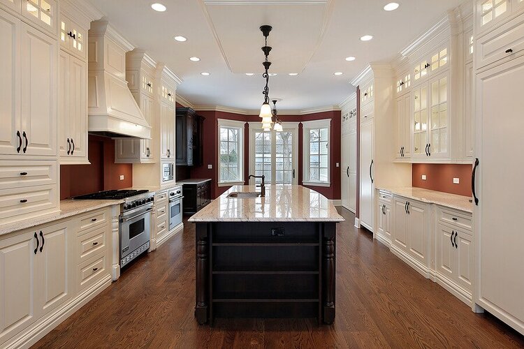 a huge kitchen area with white cabinets